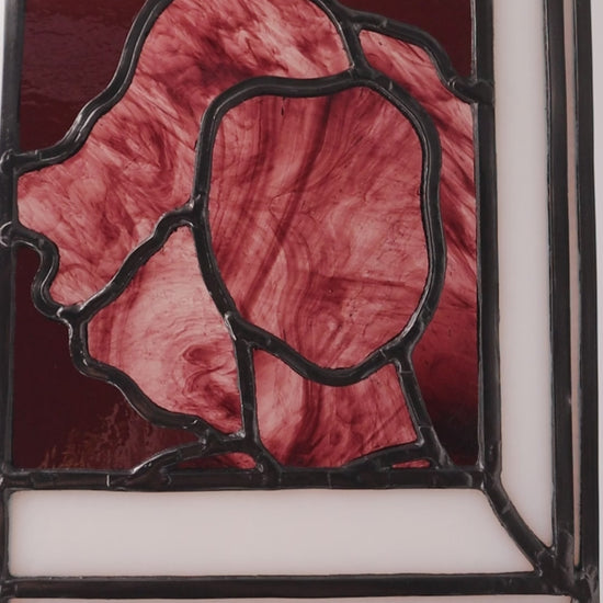 Video showing: 

Alfreda, another example of LF Kaleidoscope’s Stained Glass Portraits. This stunning artwork captures the life model reflected in a bedroom window. Alfreda’s portrait showcases her flowing hair, and beautiful torso shapes rendered in deep red, luxuriant purples with the black lead lines creating structure and definition against the white glass window frame. Alfreda is staring through the window at you, and would look excellent in any house or gallery.